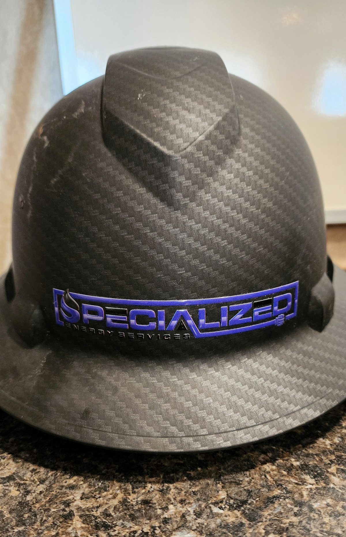 Specialized Energy Services branded hard hat on location
